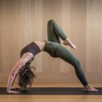 일상 속에서 쉽게 실천하는 필라테스, 건강과 활력을 더하다 a woman is doing a yoga pose on a mat