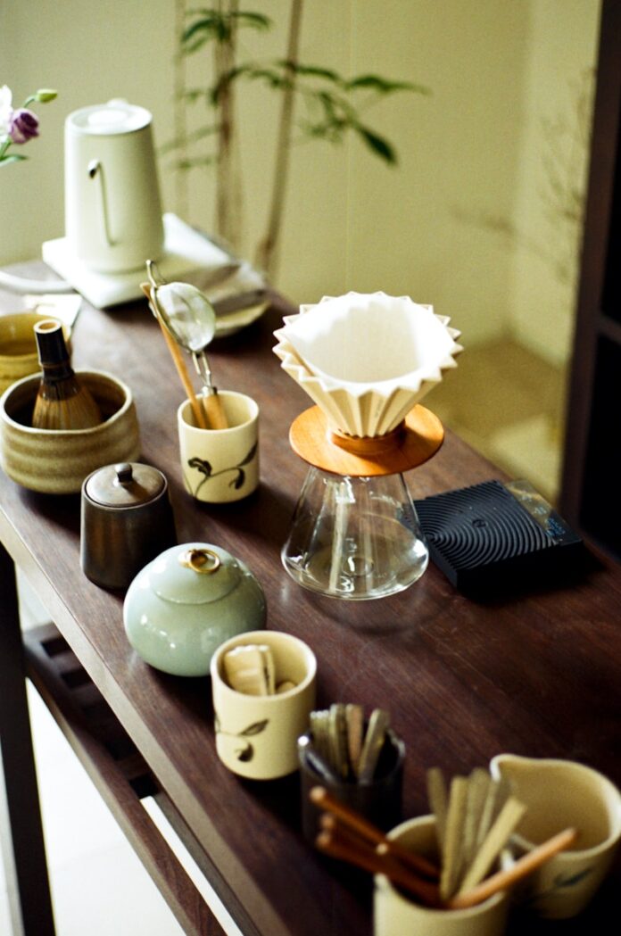 Various tea ceremony utensils arranged on a wooden table.