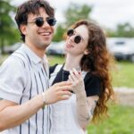 만성피로, 일상 속 작은 변화로 극복한다 Young couple laughing outdoors on a sunny day.