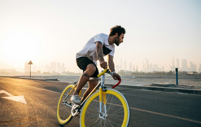 Photo by Jonny Kennaugh man riding bicycle on road during daytime